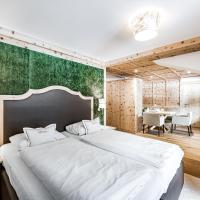 a bedroom with a large bed with a green wall at Vierjahreszeiten, Hintertux