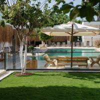 a pool with an umbrella and a bench and a table at Costa Maya Bodrum, Bodrum City