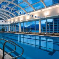 a swimming pool with a view of a building at Auberge Vancouver Hotel