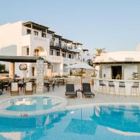 a pool at a hotel with chairs and tables at Melidron Hotel & Suites, Agios Prokopios