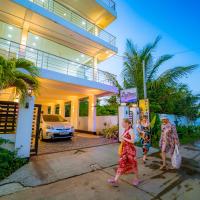 two women walking in front of a house at Liyonaa Beach Hotel, Trincomalee