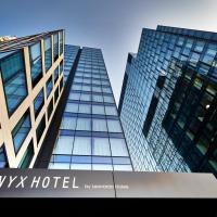 two tall buildings with a msx hotel sign in front at NYX Hotel Warsaw by Leonardo Hotels