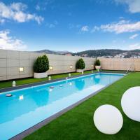 a swimming pool on the roof of a building at Hotel Andalucía Center, Granada