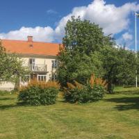 a house with a yard with trees and a flag at Stunning home in Vimmerby with 2 Bedrooms and WiFi