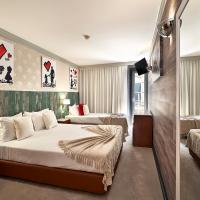 a hotel room with two beds and a television at Galeria Suite Hotel, Aveiro