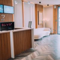a lobby with a reception desk with a tv on the wall at Hotel BLVD 7, Plovdiv