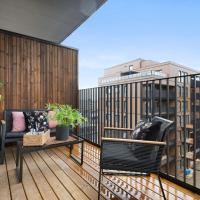 a balcony with two chairs and a table on a building at 10 min to Oslo senter Beautiful and newly performed 2-room rooms wih large, sunny balcony of 9 sqm, Lillestr&oslash;m