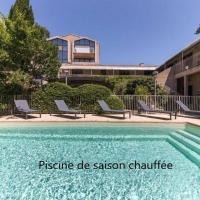 a swimming pool with chairs next to a building at Hotel Cantosorgue, L'Isle-sur-la-Sorgue