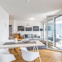 a dining room and living room with a white table and chairs at Penthouse Ferienwohnung, Bahlingen