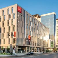 a large building on a street in a city at ibis Baku City