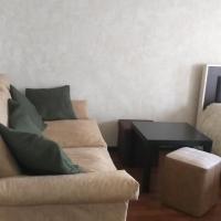 a living room with a couch and a table at Apartment in Poti