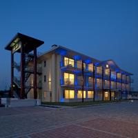 a large building with lights on at night at Hotel Rivus, Peschiera del Garda