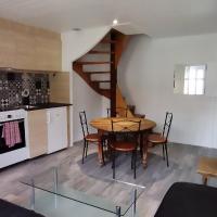 a kitchen and dining room with a table and a staircase at Clisson duplex dans quartier plein de charme