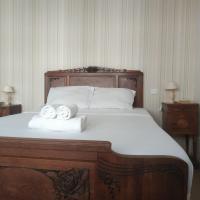 a bedroom with a large bed with two towels at Classic House, Argentat