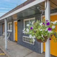 a building with a hanging basket of flowers at Minecart Motor Lodge, Montrose