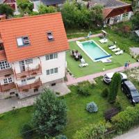 an aerial view of a house with a swimming pool at Pensiunea Apolka Panzió, Covasna