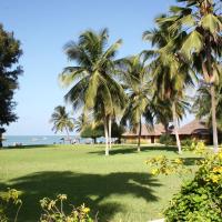 a park with palm trees and the ocean in the background at Le Saly Hotel & Hotel Club Filaos, Saly Portudal