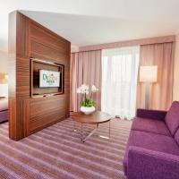 a hotel room with a purple couch and a bed at Hotel DeSilva Premium Opole