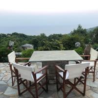 a table and chairs on a stone patio at Infinity Guest House, Kissos