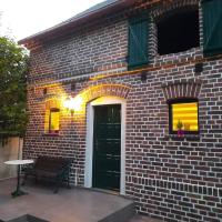 a brick building with a black door and a table at apartament typu agro z tarasem, Milicz