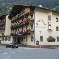 a building with flowers on the balconies on a street at Hotel Untermetzger, Zell am Ziller