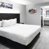 a hotel room with a large bed and a desk at Hollywood Inn Express LAX, Inglewood