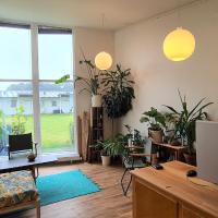 an apartment with plants and a desk in a room at 2 room apartment close to MCH, Herning