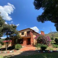 a large brick house with a large driveway at BS HOTEL CAMPESTRE, Cucunubá