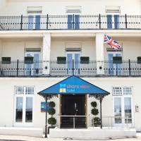 a building with a blue awning and an american flag at Shore View Hotel, Eastbourne