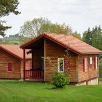 a small wooden cabin with a red roof at Village de Gîtes du Malzieu, Le Malzieu-Ville