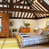 a large bedroom with a bed and a dresser at B&B at The Old Mill, Devizes