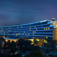 a large building with lights on at night at Wyndham Qingdao
