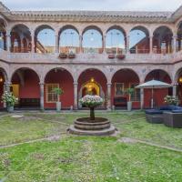 a courtyard in an old building with a fountain at Costa del Sol Wyndham Cusco