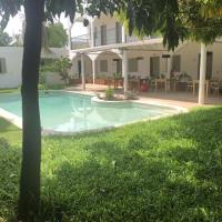 a swimming pool in the yard of a house at le HBR de Saly, Saly Portudal