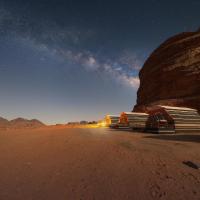 a group of trucks parked in the desert at night at Rum Stars Camp, Wadi Rum