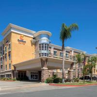 a hotel building with a palm tree in front of it at Comfort Suites Ontario Airport Convention Center
