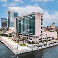 a large building next to a body of water at Hyatt Regency Jacksonville Riverfront