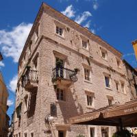 a large stone building with a balcony on it at Heritage Hotel Life Palace, Šibenik