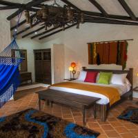 a bedroom with a bed with a blue canopy at Casona Quesada, Suesca