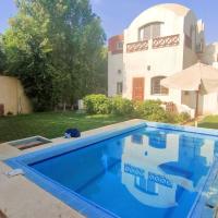 a swimming pool in front of a house at Touha House, Fayoum