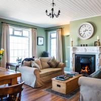 a living room with a couch and a fireplace at Margaret's Cottage B&B, Ardglass
