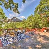 a deck with an umbrella and a table and chairs at Norfork Lake Getaway Deck, 6 Mi to Main St!, Mountain Home