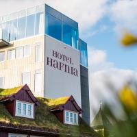 a hospital building with a building with a grass roof at Hotel Hafnia, Tórshavn