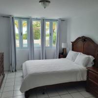 a bedroom with a large bed and a window at Brisas De Hacienda (Close to Hacienda Campo Rico), Carolina