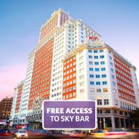 a large building with a free access to sky bar sign at Riu Plaza España, Madrid