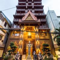 a tall building with a statue in front of it at Okay Boutique Hotel, Phnom Penh