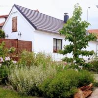 a garden in front of a white house at Onefourfour Apartment, Brandýs nad Labem-Stará Boleslav