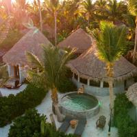 an aerial view of a resort with a swimming pool and palm trees at Maya Tulum By G Hotels