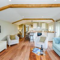a living room with a couch and a table at Stackyard Cottage, Barnoldswick