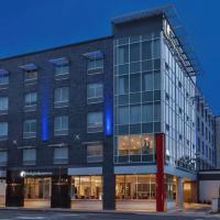 a building with blue lights on the side of it at Holiday Inn Express & Suites Jersey City - Holland Tunnel, an IHG Hotel